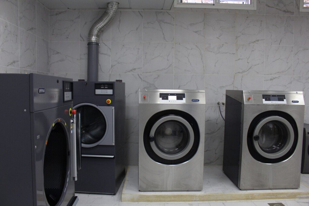 آلات غسيل صناعية داخل غرفة مغسلة في مبرة الإمام الرضا (ع) في لبنان | Industrial washing machines inside a laundry room at Imam Al-Ridha Institution in Lebanon